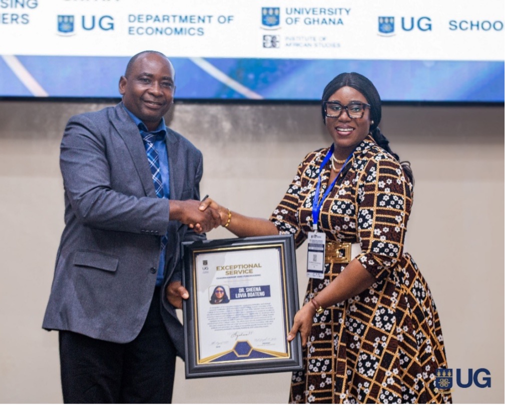 Prof. Joseph Yaro presenting an award to Dr. Sheena Lovia Boateng